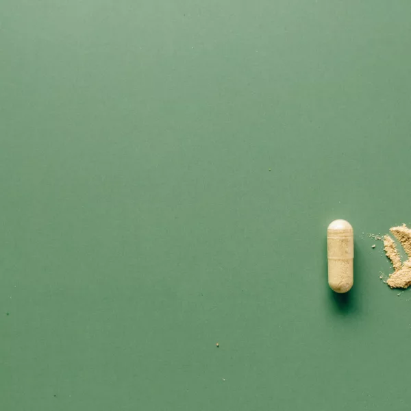 Stylized image of a pill and a crushed pill
